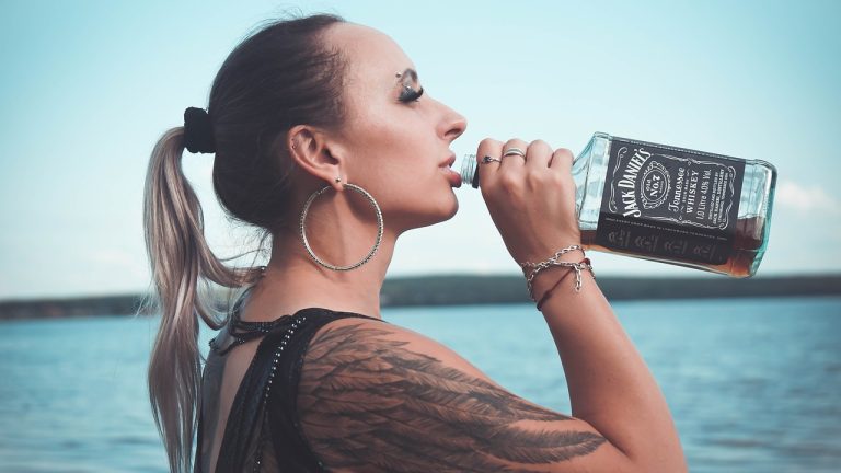 woman drinking Jack Daniels out of the bottle